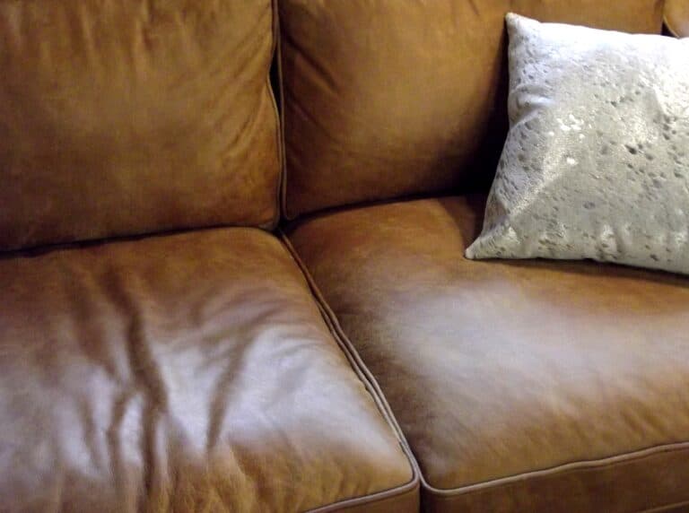 home decor brown leather sofa with a silver cush 2022 11 15 16 42 45 utc